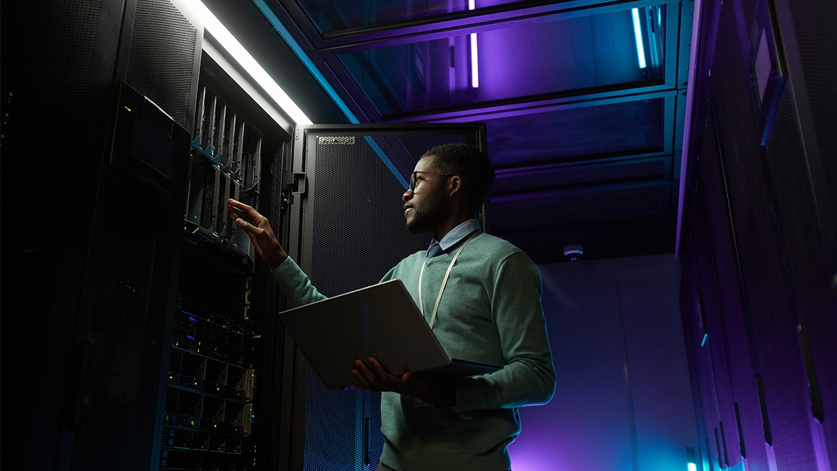 Man with a laptop working on a server