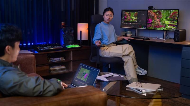 Woman and man doing design work at workstation