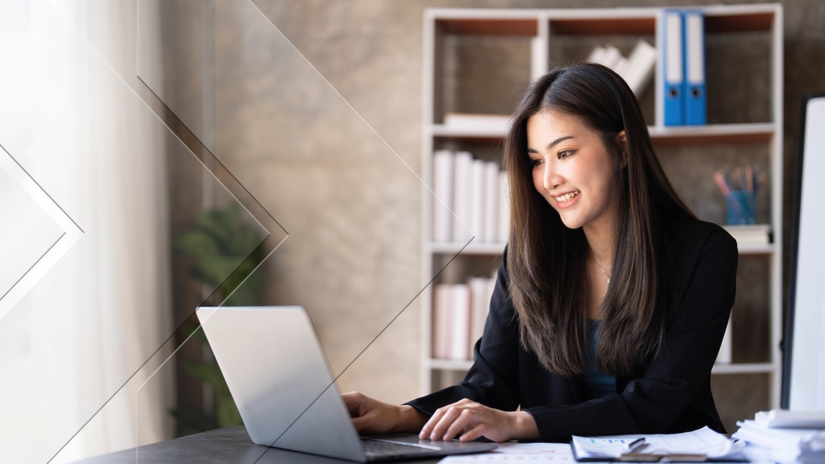 Woman sitting in office at her laptop working