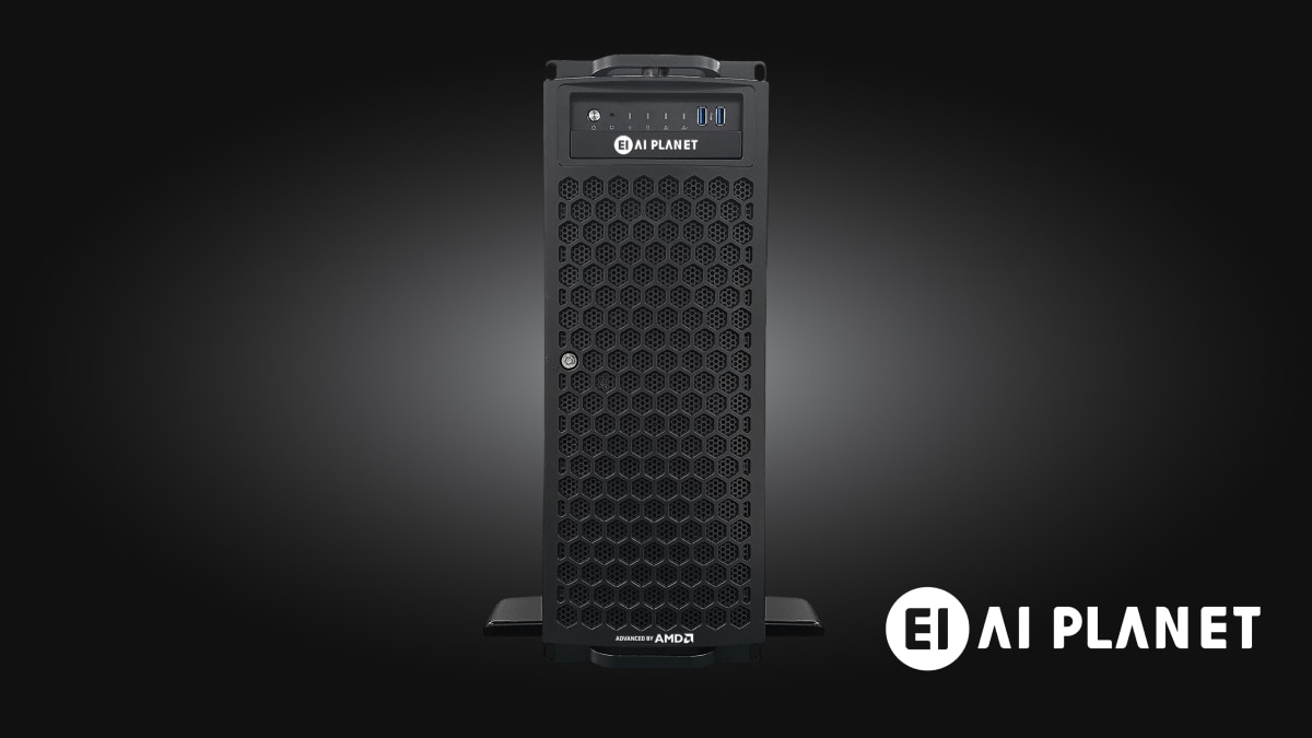 AI Planet tower server with hexagonal mesh front, USB ports, power button, and “AI PLANET” and “Advanced by AMD” labels