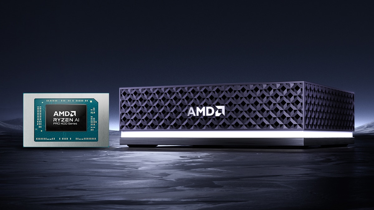 Ryzen AI PRO 400 Series processor beside a black mini PC with geometric front grille and illuminated base on a dark background.