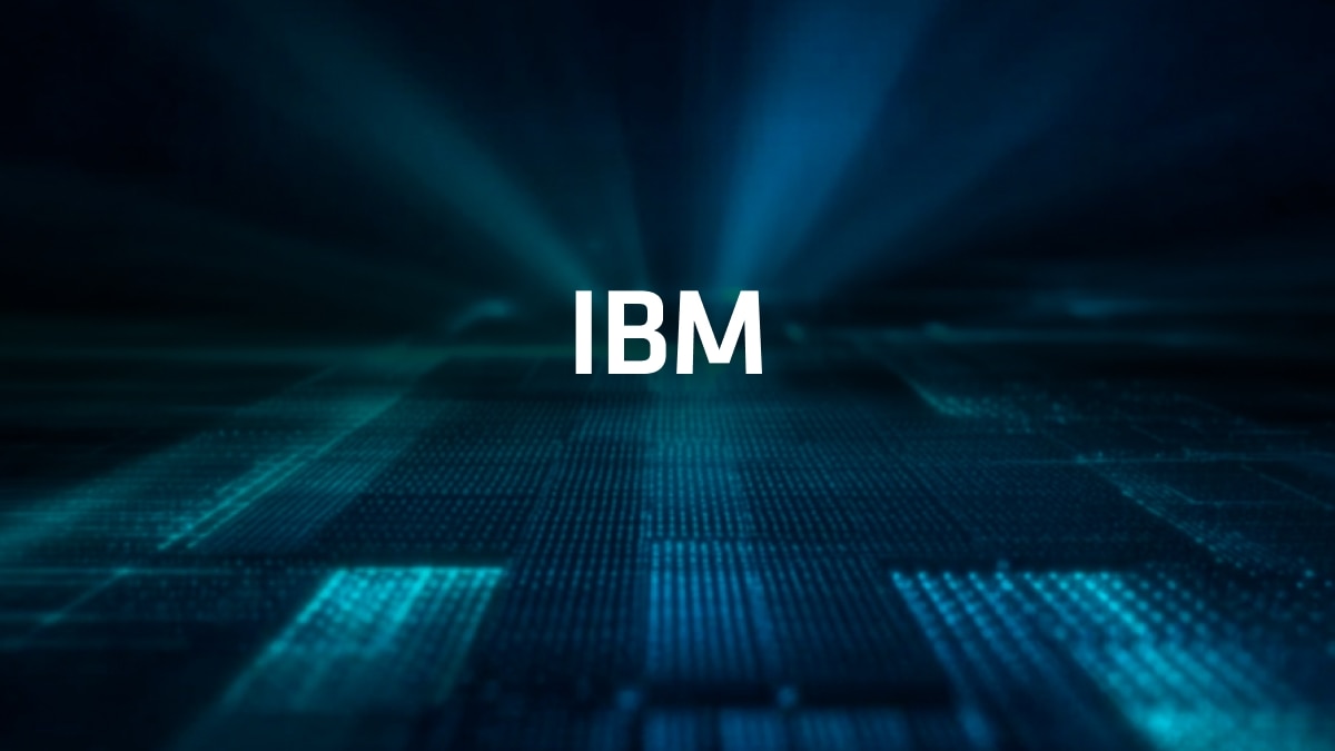 White "IBM" text centered on a dark blue digital background with glowing grid and light rays.