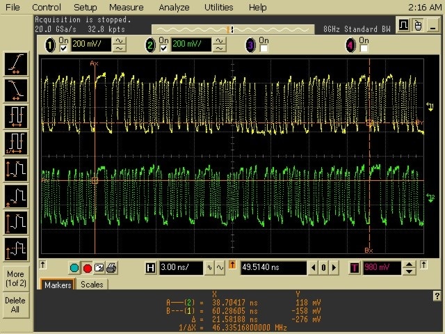 Oscilloscope screen showing yellow and green waveforms with voltage readings and timing markers.