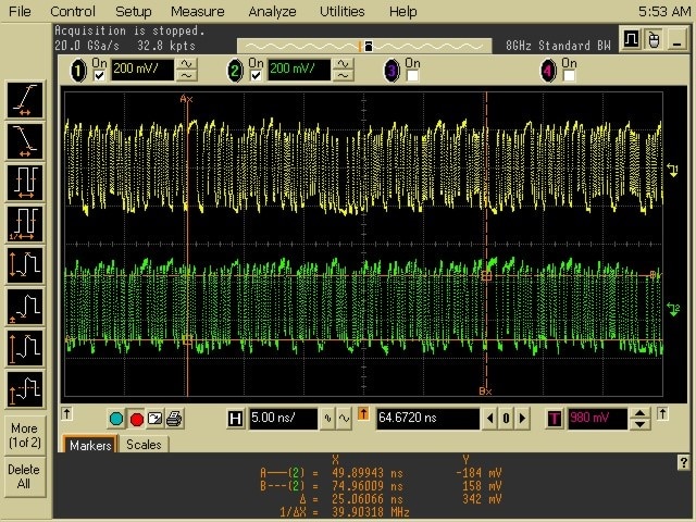 Oscilloscope capture with dense yellow and green waveforms, signal measurements, and timing markers.